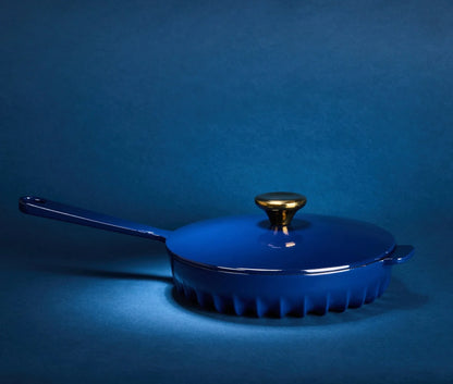 The FIREUP Oxford Blue cast iron skillet baking in an oven to demonstrate its superior heat distribution.