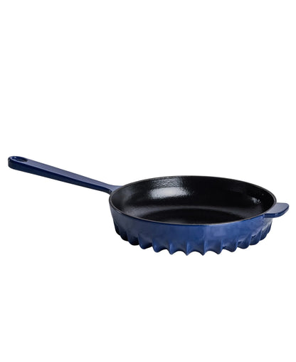 The FIREUP cast iron skillet in Oxford Blue featuring the patented rapid heat fin design base.