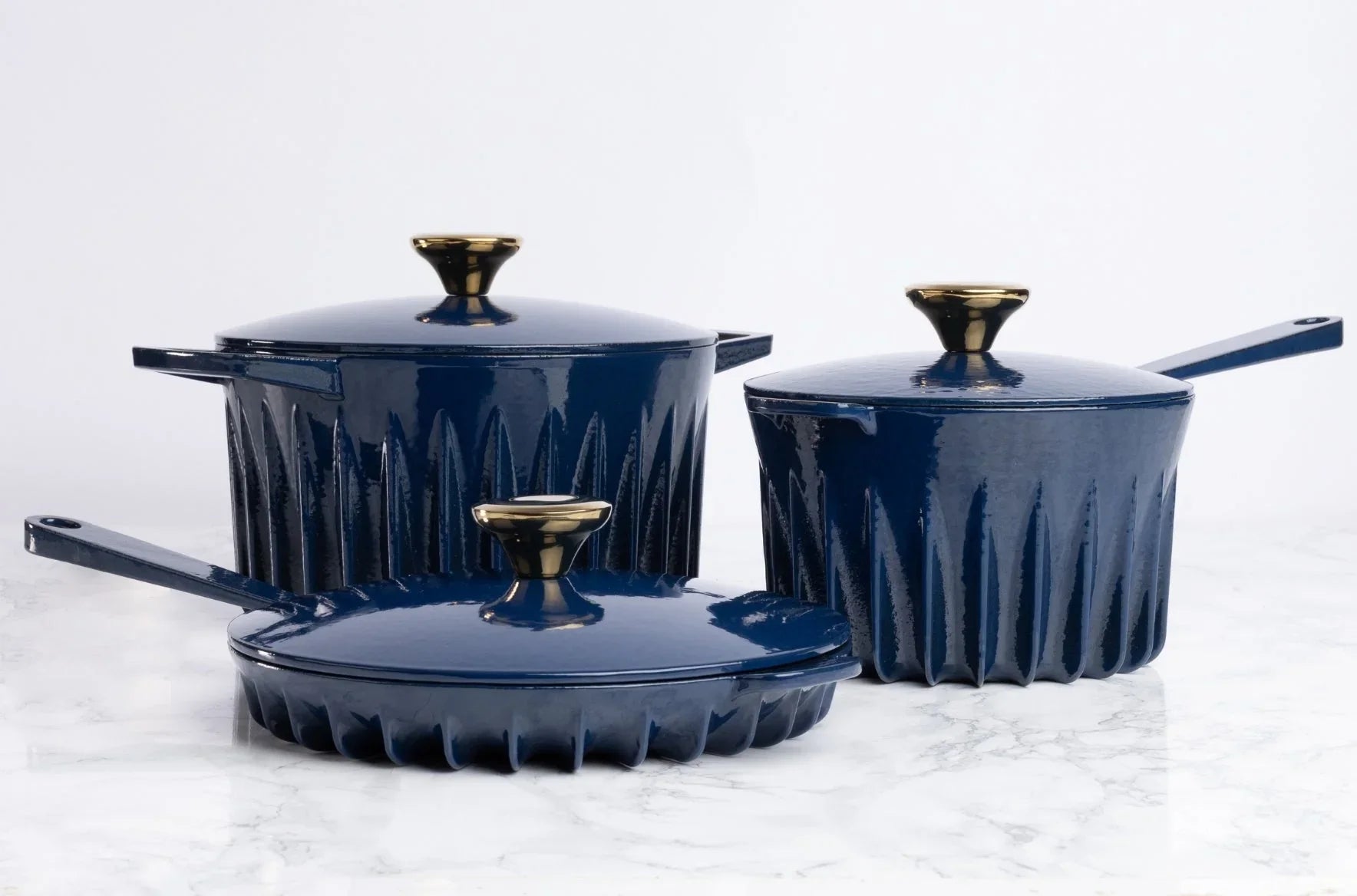 Lifestyle view of the FIREUP Oxford Blue skillet other cookware on a kitchen countertop highlighting its iconic design and ergonomic handles.