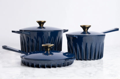 Lifestyle view of the FIREUP Oxford Blue skillet other cookware on a kitchen countertop highlighting its iconic design and ergonomic handles.