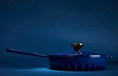 Side profile of the Oxford Blue FIREUP skillet highlighting the thin fin design base and hanging hole handle.