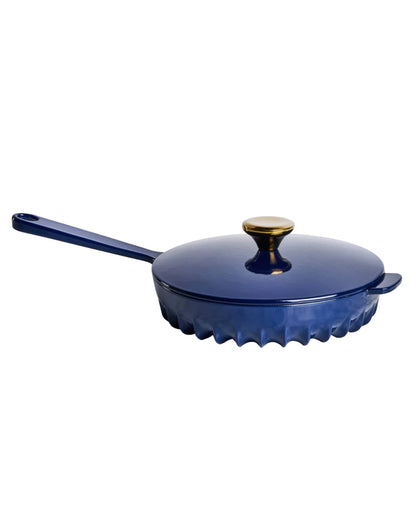 Close-up of the FIREUP fin design skillet base in Oxford Blue showing patented heat distribution fins.