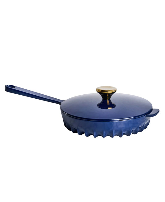 Close-up of the FIREUP fin design skillet base in Oxford Blue showing patented heat distribution fins.
