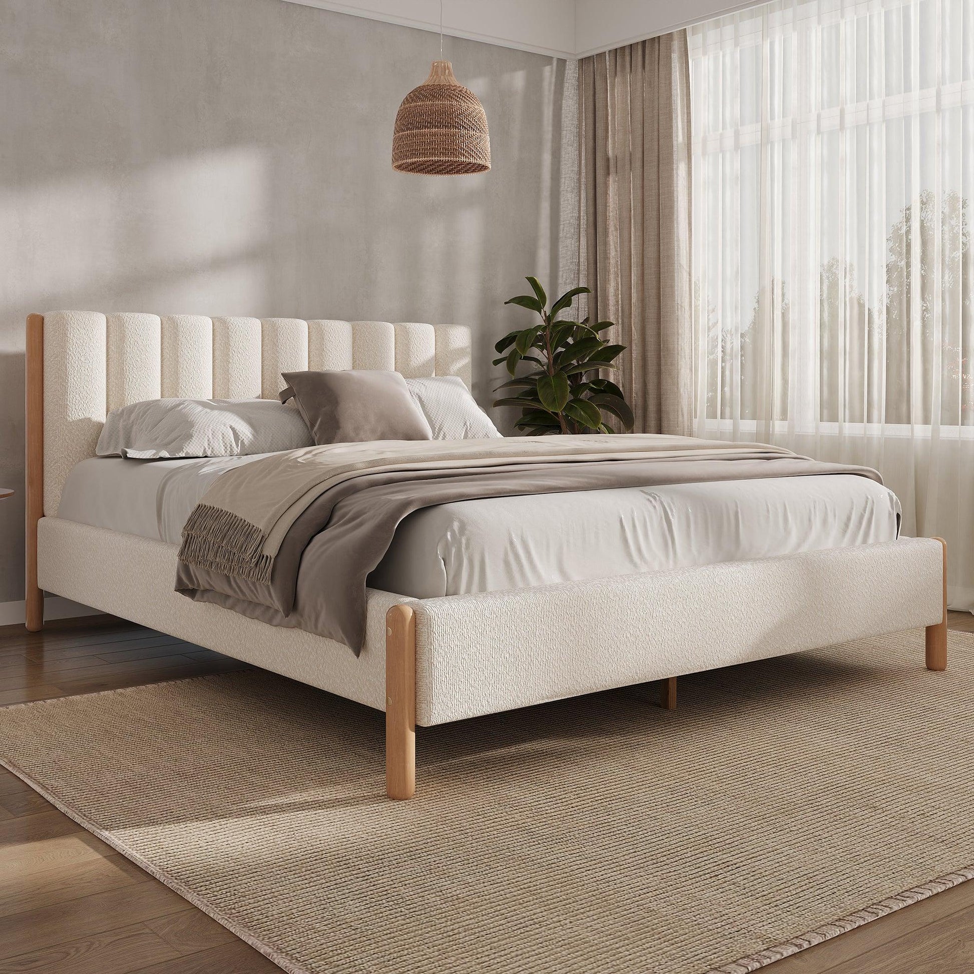 White bouclé queen bed frame with vertical panel headboard and natural rubberwood legs in bright neutral bedroom with sheer curtains and rattan pendant

