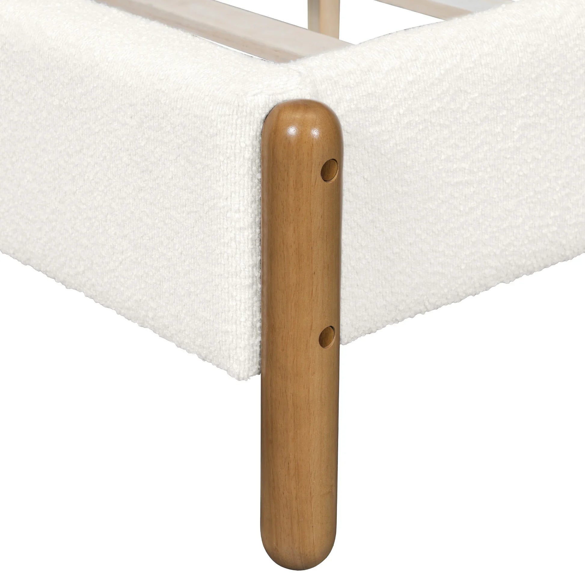 Close-up of natural rubberwood leg corner detail on white bouclé queen bed frame showing rounded cylindrical form and assembly hardware

