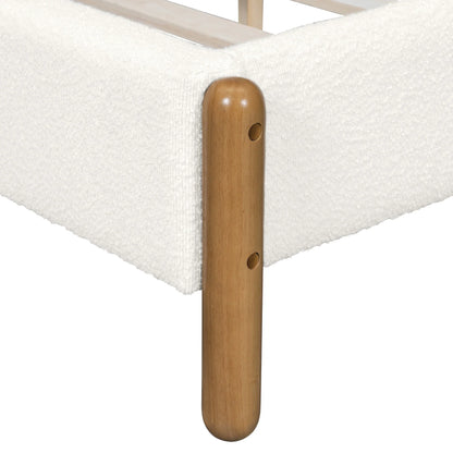 Close-up of natural rubberwood leg corner detail on white bouclé queen bed frame showing rounded cylindrical form and assembly hardware

