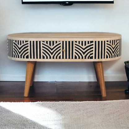 Edessa bone inlay coffee table front view showing geometric black and white inlay pattern across drawer front with tapered mango wood legs on hardwood floor


