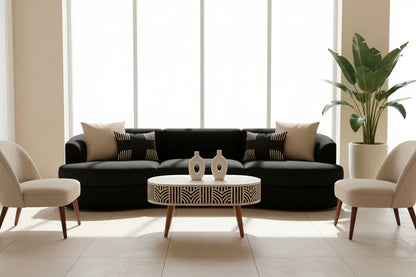Edessa bone inlay coffee table styled in a modern living room with black sofa cream bouclé chairs ceramic vases and tropical plant in bright natural light

