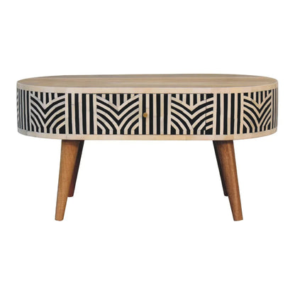 Edessa bone inlay coffee table studio shot showing full round form with geometric black and white inlay drawer and tapered mango wood legs on white background

