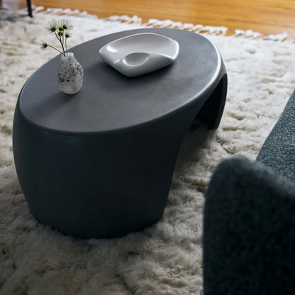 Black Micro Terrazzo Nook concrete coffee table styled with speckled ceramic vase and sculptural white dish on ivory shag rug


