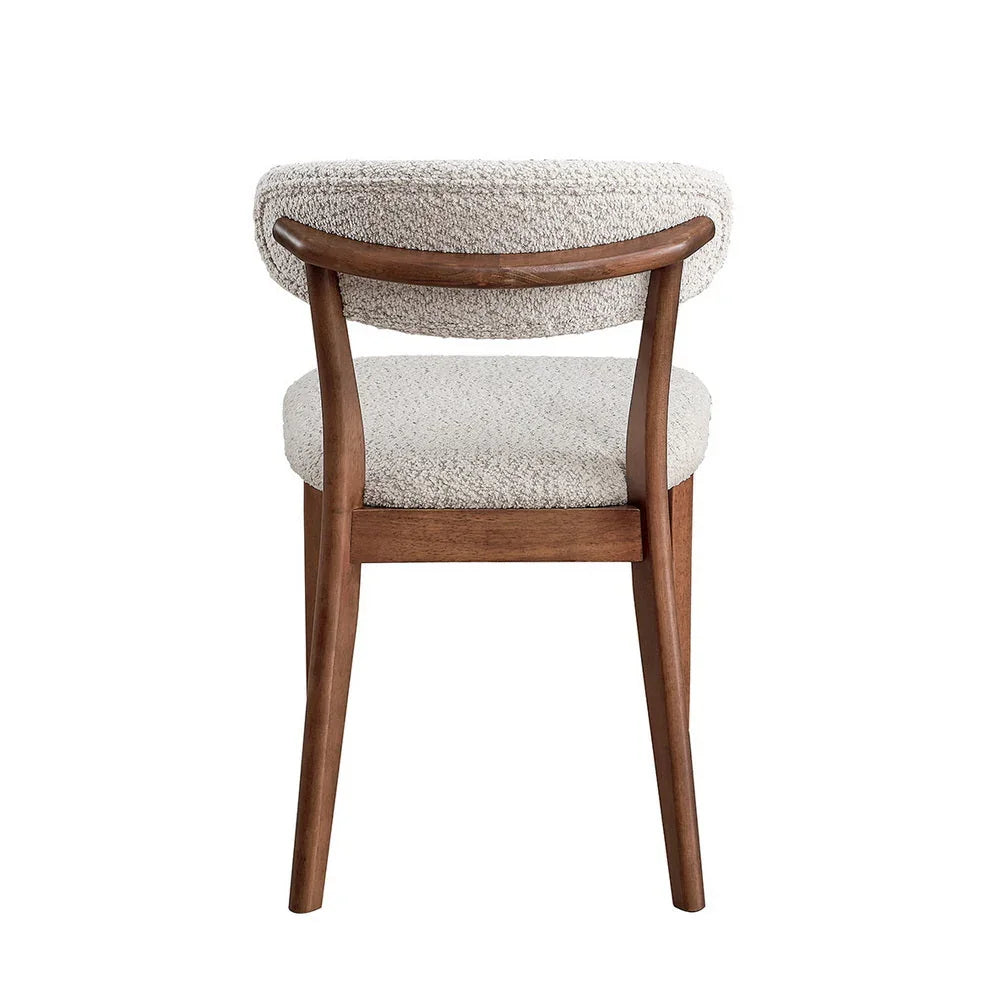 Cherry Scandinavian dining chair with bouclé upholstered backrest and curved solid wood frame shown from rear on white studio background

