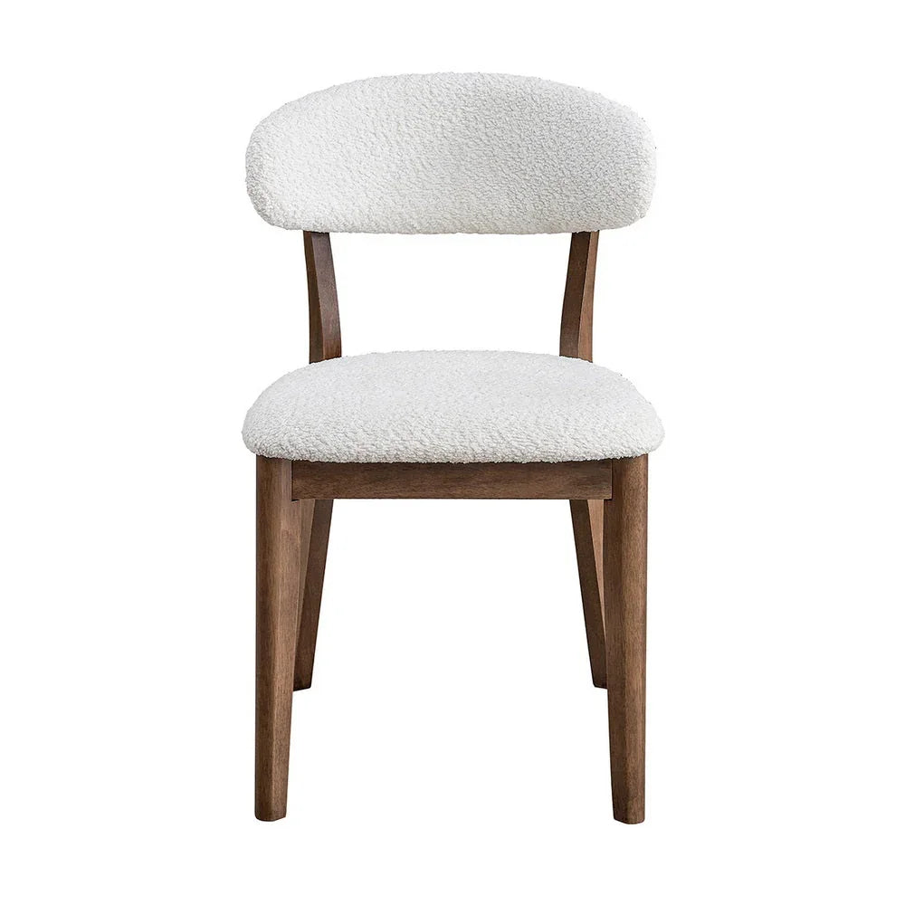 Walnut Scandinavian dining chair with bouclé upholstered seat and curved backrest shown from front on white studio background

