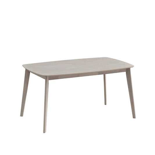 White-washed Scandinavian dining table with rounded corners and tapered solid wood legs on white studio background

