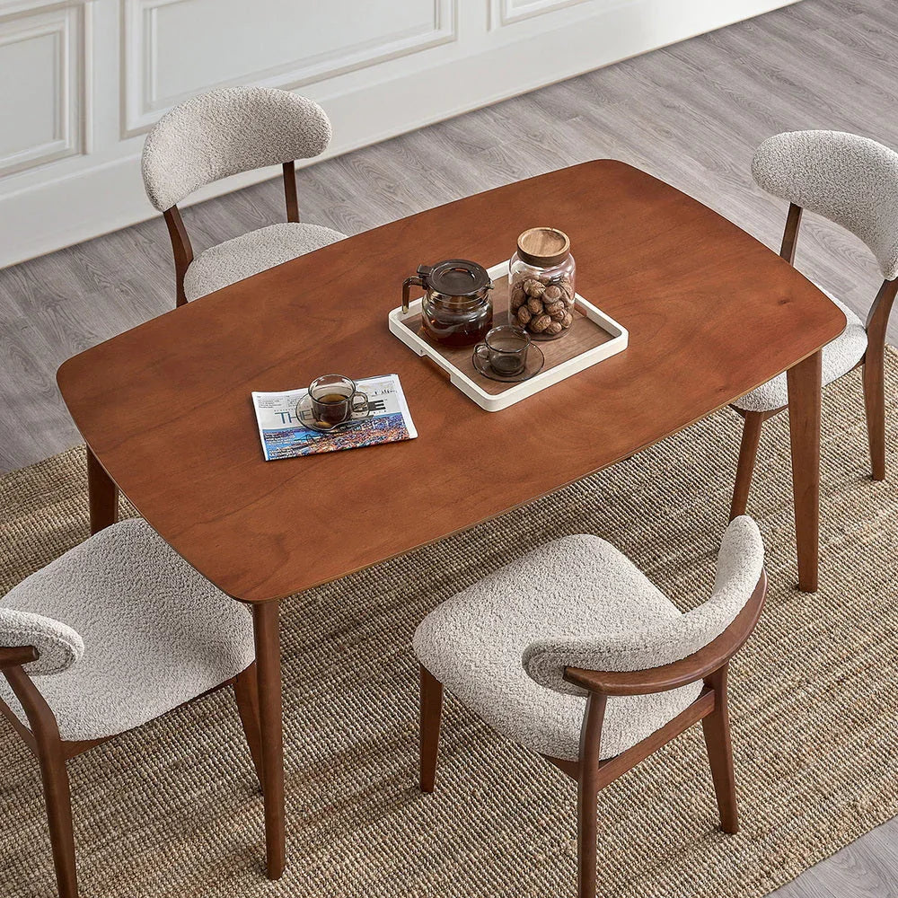 Cherry Scandinavian wood dining set overhead view with four bouclé chairs coffee service tray and magazine on jute rug

