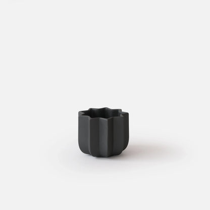 Black Wrap Planter 4 inch mini size empty on white studio background showing compact sculptural ridge form

