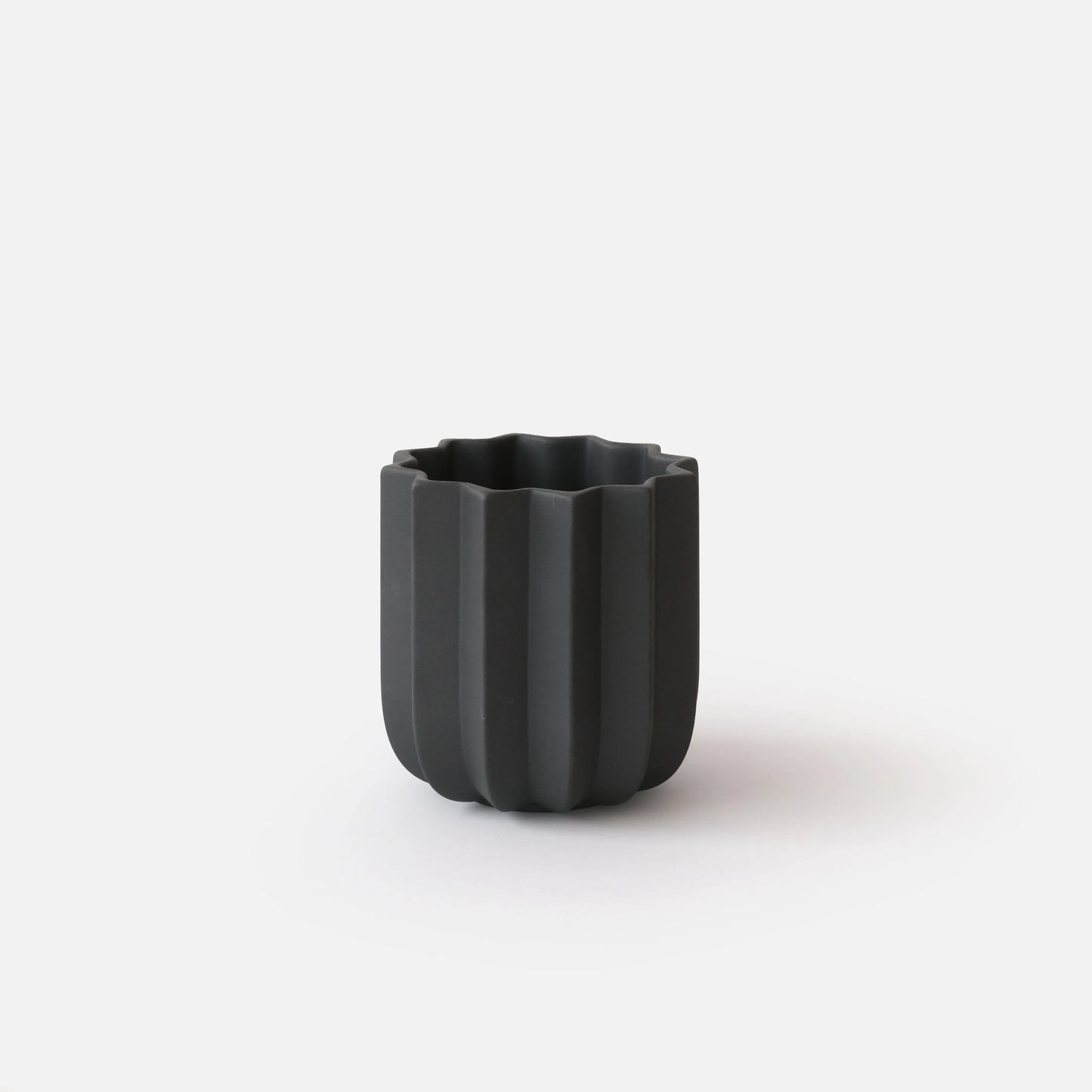 Black Wrap Planter 5 inch small size empty on white studio background showing tall sculptural vertical ridge form

