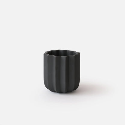 Black Wrap Planter 5 inch small size empty on white studio background showing tall sculptural vertical ridge form

