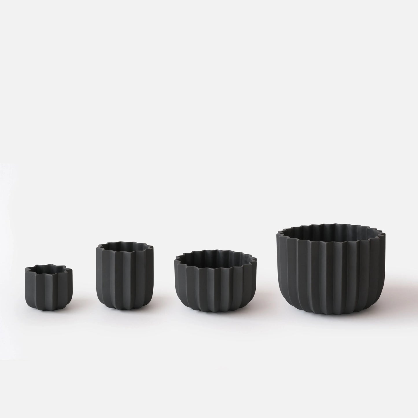 Black Wrap Planter all four sizes displayed empty on white studio background showing size progression from small to large

