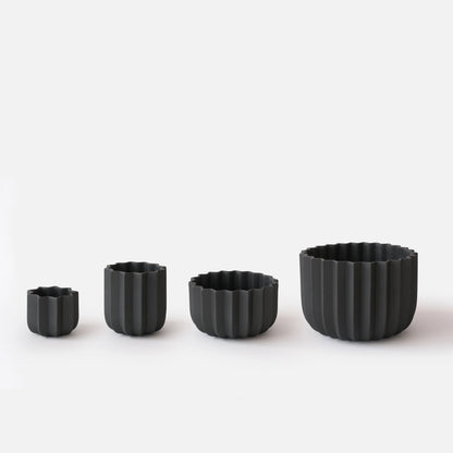 Black Wrap Planter all four sizes displayed empty on white studio background showing size progression from small to large

