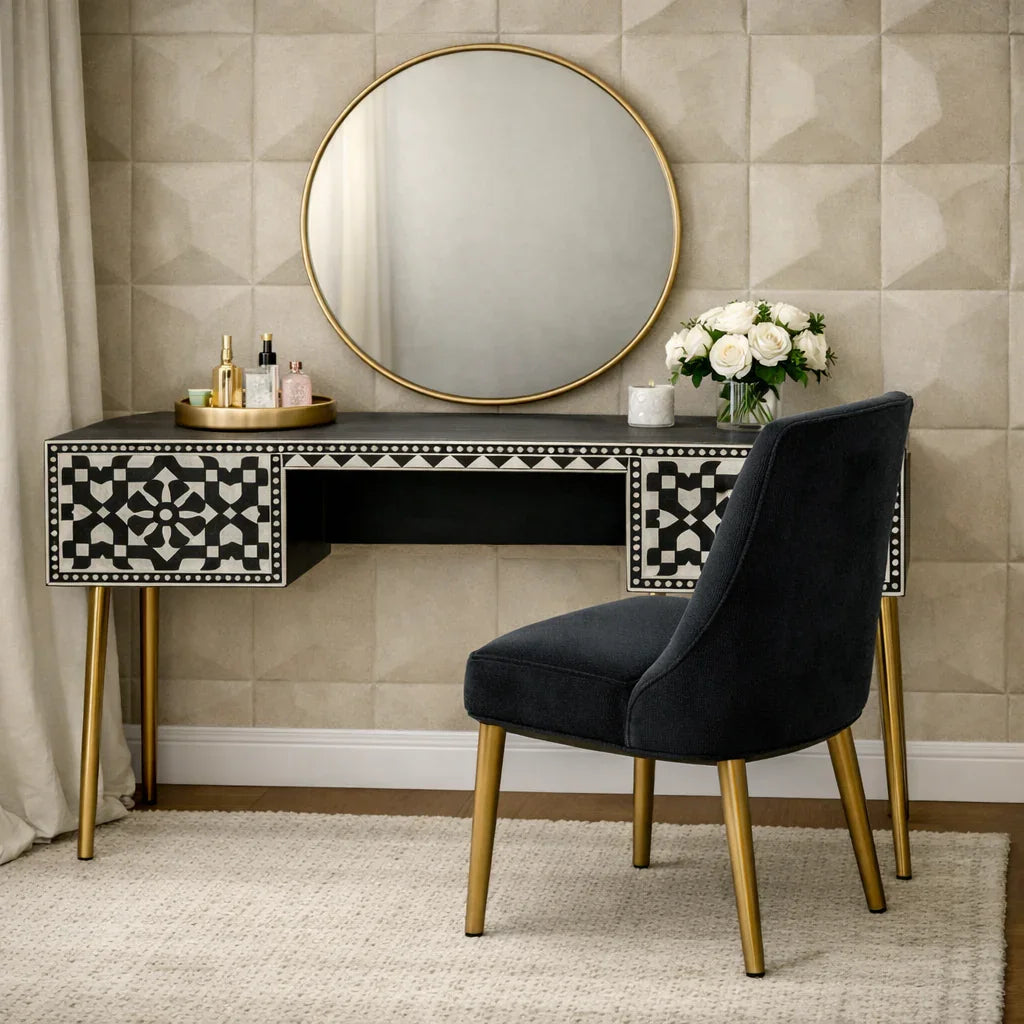 Black and white bone inlay console desk styled as a vanity with gold mirror florals and perfume in a bedroom