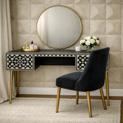 Black and white bone inlay console desk styled as a vanity with gold mirror florals and perfume in a bedroom
