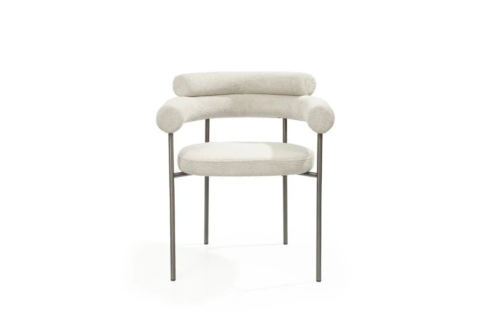 Light gray boucle dining arm chairs featuring a unique open back design and durable gunmetal stainless steel frames.