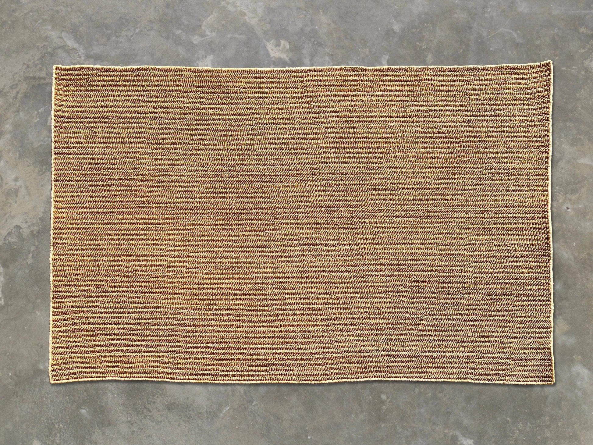 Full flat lay of handwoven rectangular sisal rug tea variant showing golden amber russet weave cream binding and full dimensions