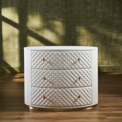 Harvard Quilted Three-Drawer Leather Chest white oval silhouette three drawers brass knobs gold base front view dappled light green wall hardwood floor