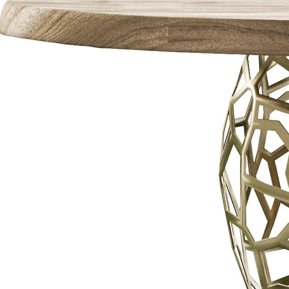 Close-up of the acacia tabletop’s wood grain and live edge beside the geometric openwork of the brass-finished steel pedestal.