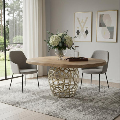 Acacia live edge dining table with a brass-finished openwork pedestal, styled with gray chairs and white flowers in a bright dining room.
