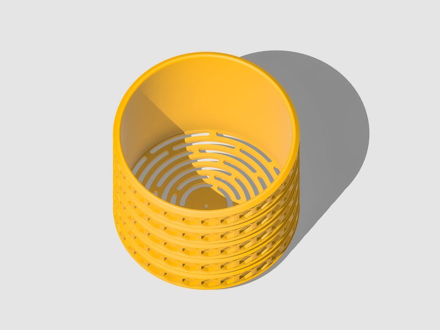 Orion hexagonal plant pot in Mustard, overhead view showing drainage openings, light grey background