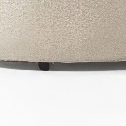 Close up of ivory boucle sectional base showing looped fabric texture detail and small dark leg construction on a white background
