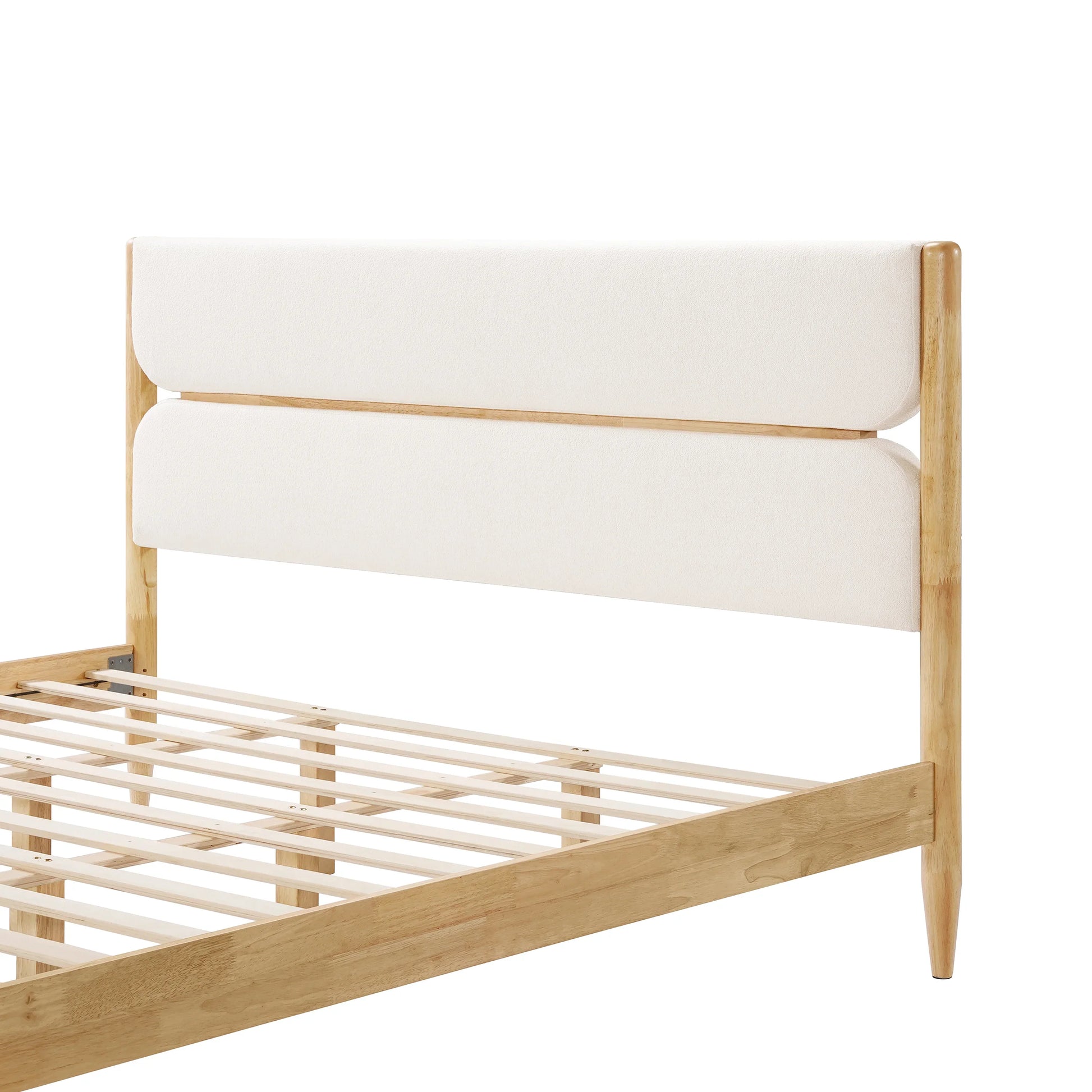  A close-up view of a King Platform Bed showcasing the high-profile headboard wrapped in premium Ivory Fleece Furniture fabric with a graceful curved hollow design.