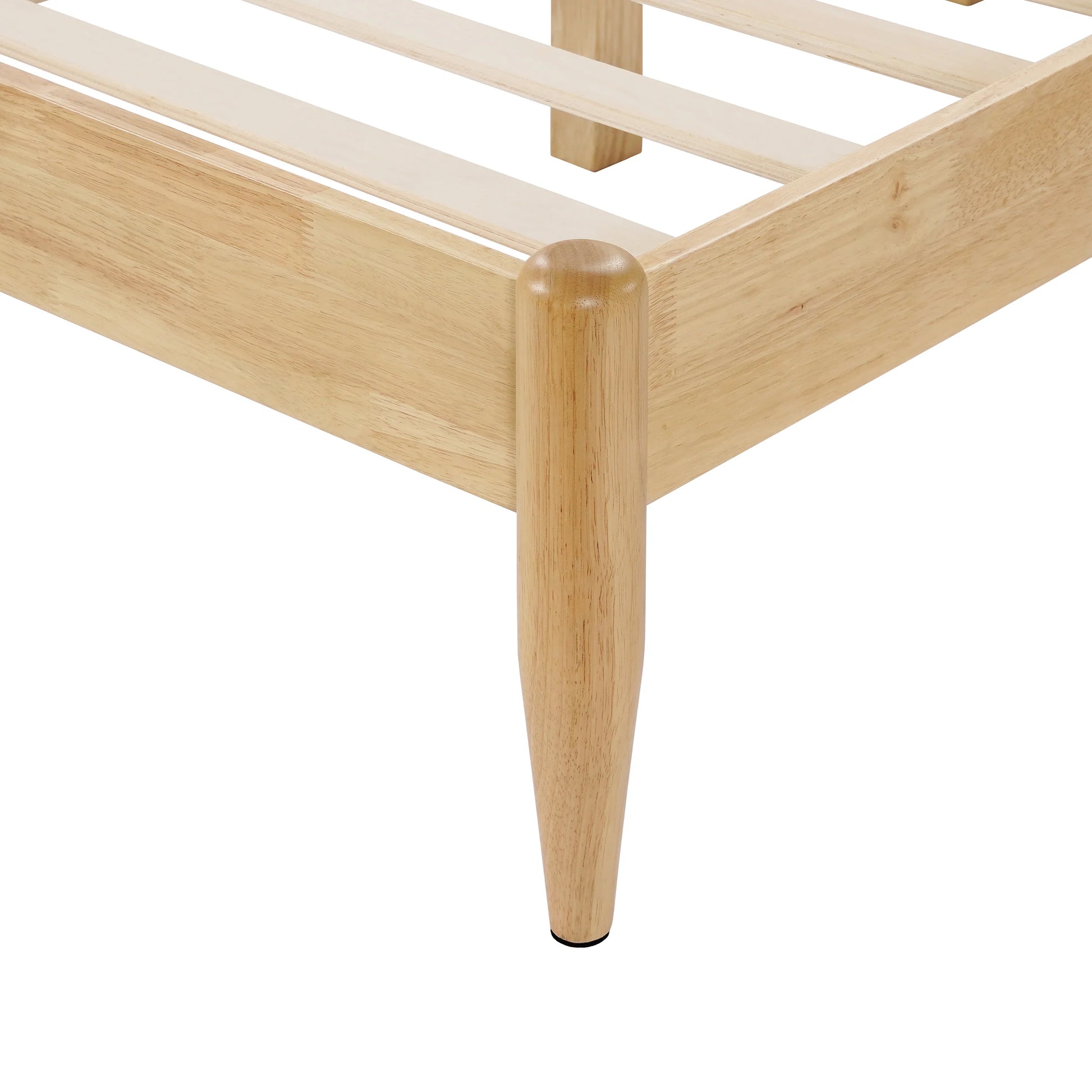  A close-up view of a Durable Rubberwood Frame corner showcasing the sleek, tapered solid wood leg and precise joinery of a King Platform Bed.