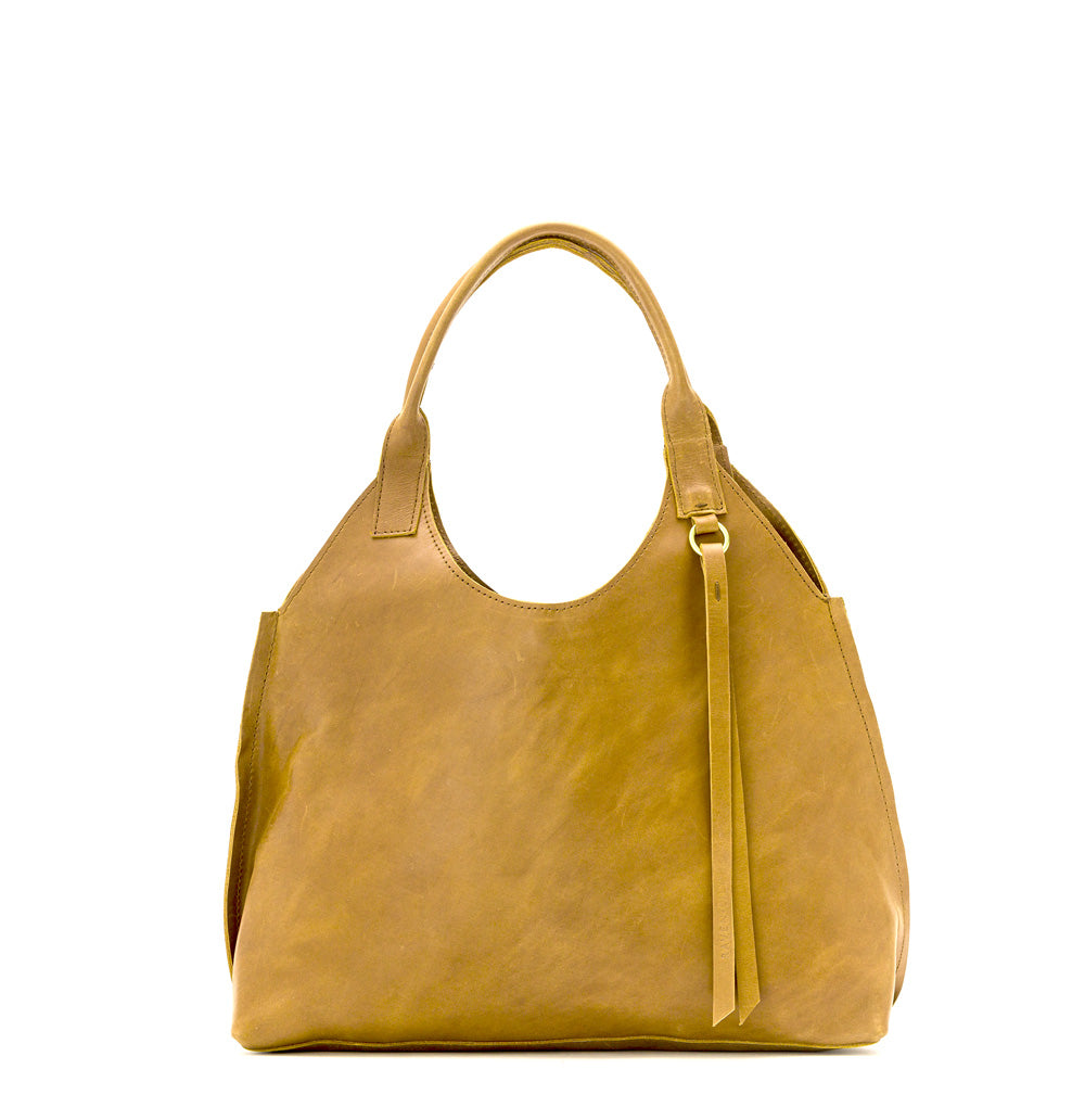 Lady Bird Tote Dijon natural leather front view white background short top handles brass o-ring tassel detail retro silhouette

