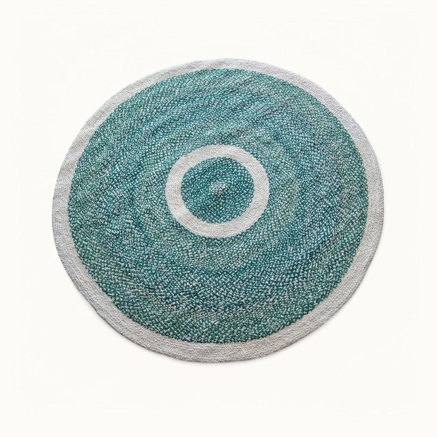 Handwoven round sisal rug forest green variant with teal green braided field cream circle ring motif and light grey border on white background