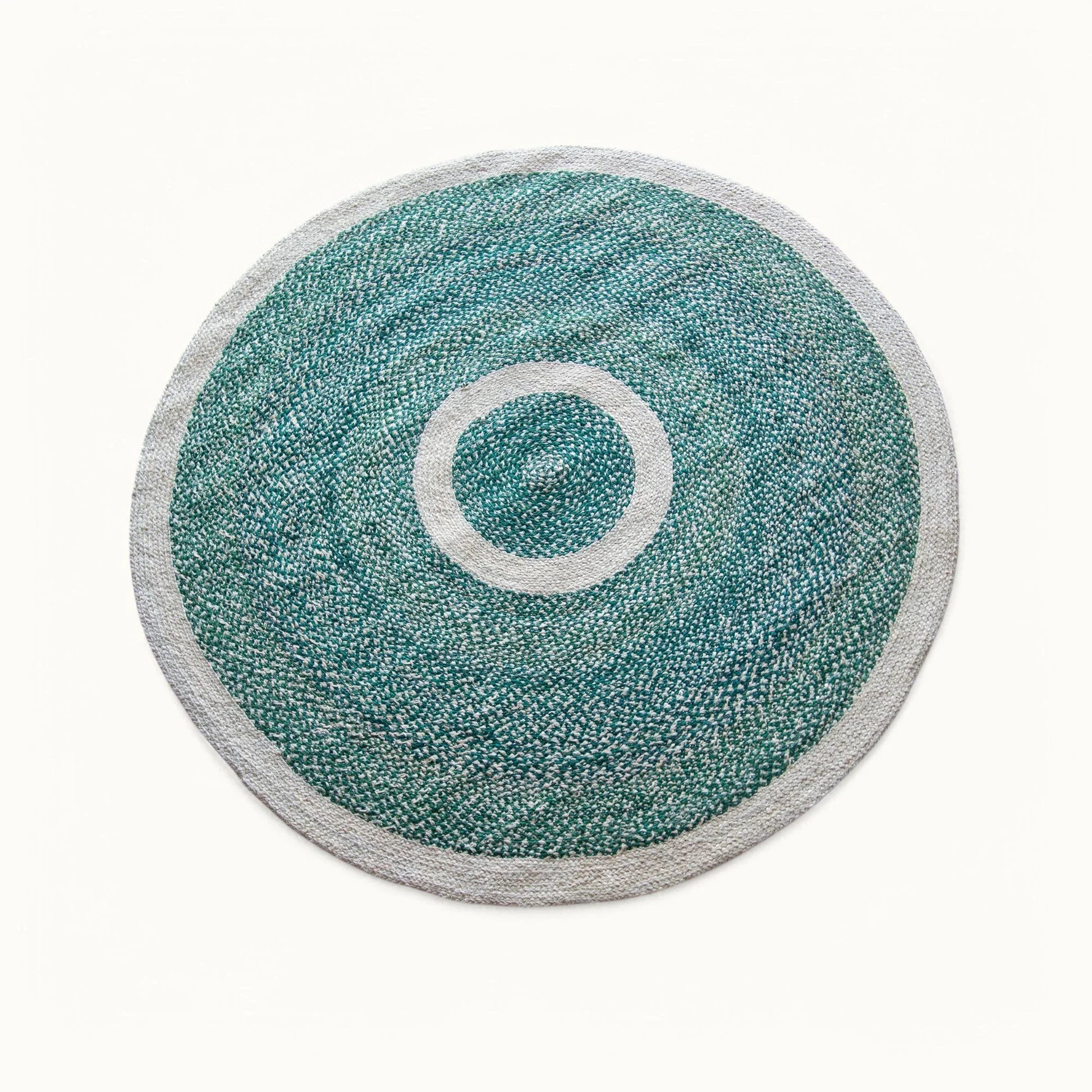 Handwoven round sisal rug forest green variant with teal green braided field cream circle ring motif and light grey border on white background
