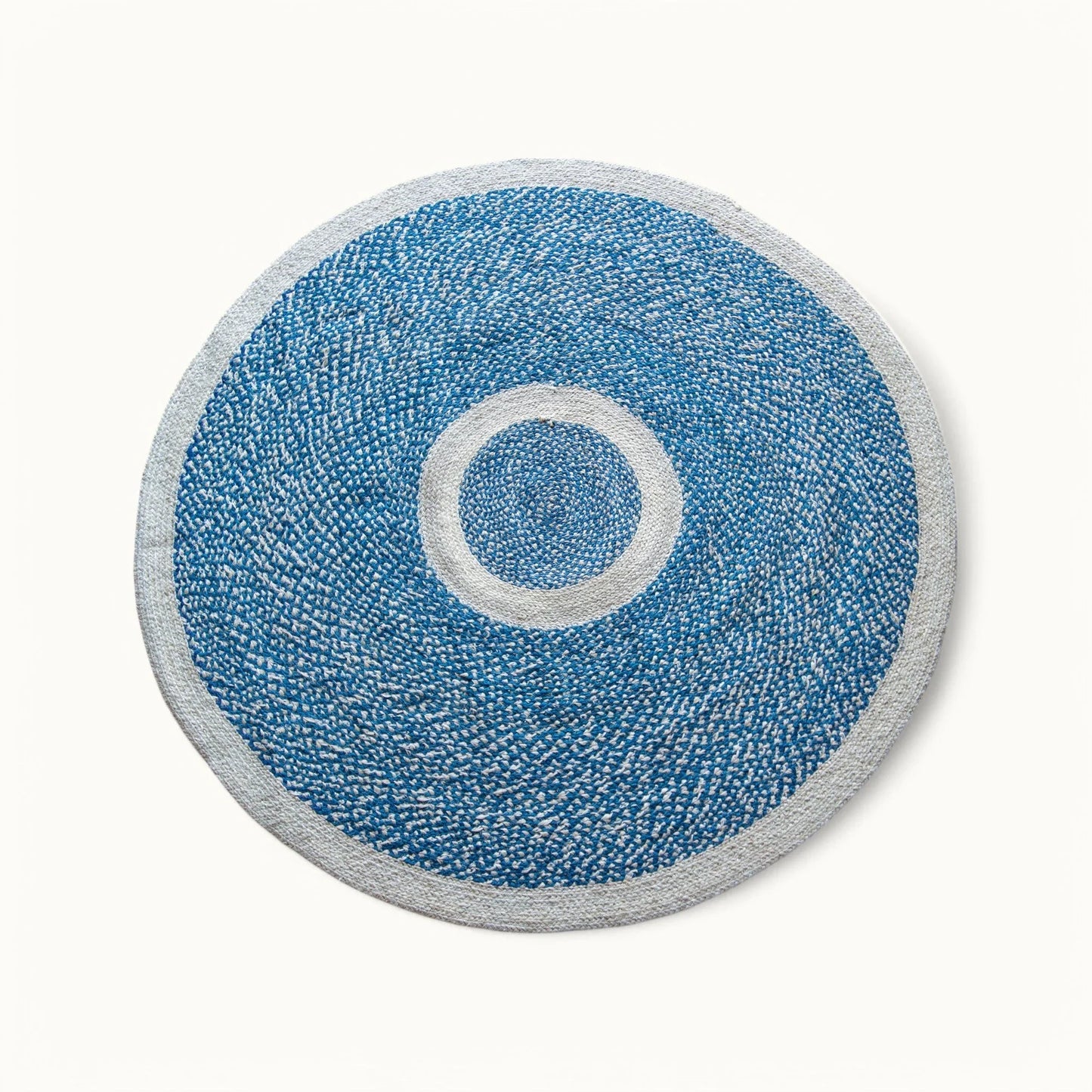 Handwoven round sisal rug marine blue variant with cream circle ring motif and light grey border on white background