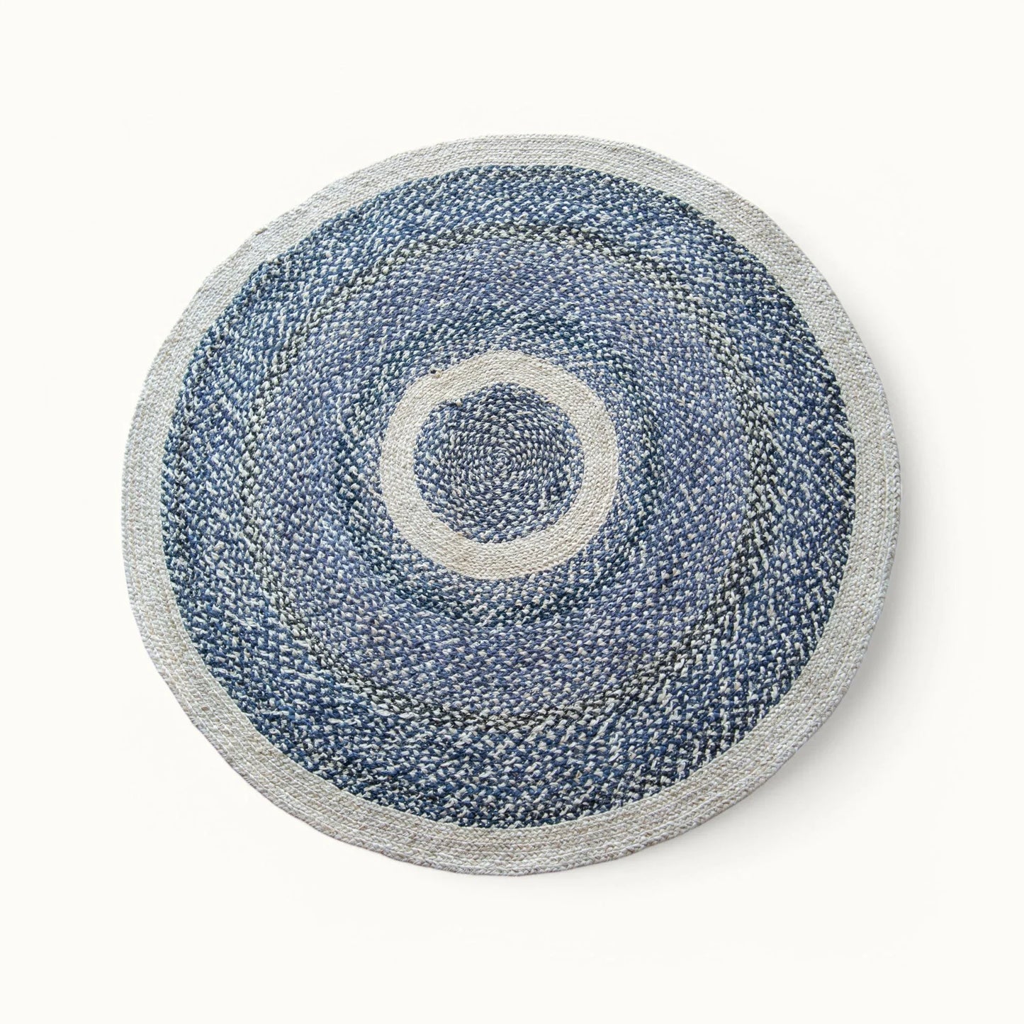 Handwoven medium round sisal rug black variant with cream circle ring motif and light grey border on white background