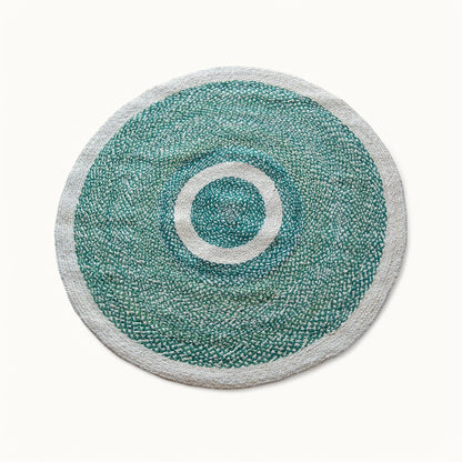 Handwoven medium round sisal rug forest green variant with cream circle ring motif and light grey border on white background