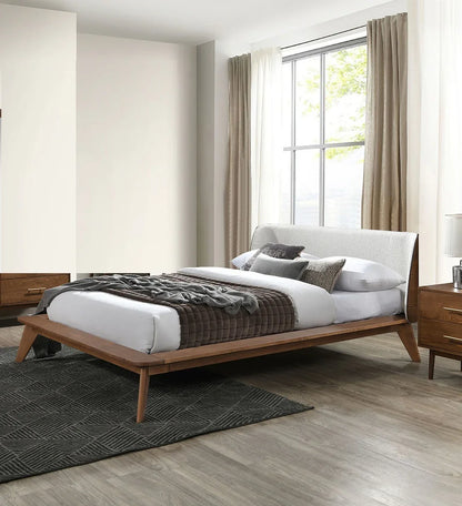 ​An editorial bedroom layout featuring a mid century full bed walnut frame styled with a plush quilted throw blanket and matching modern nightstands