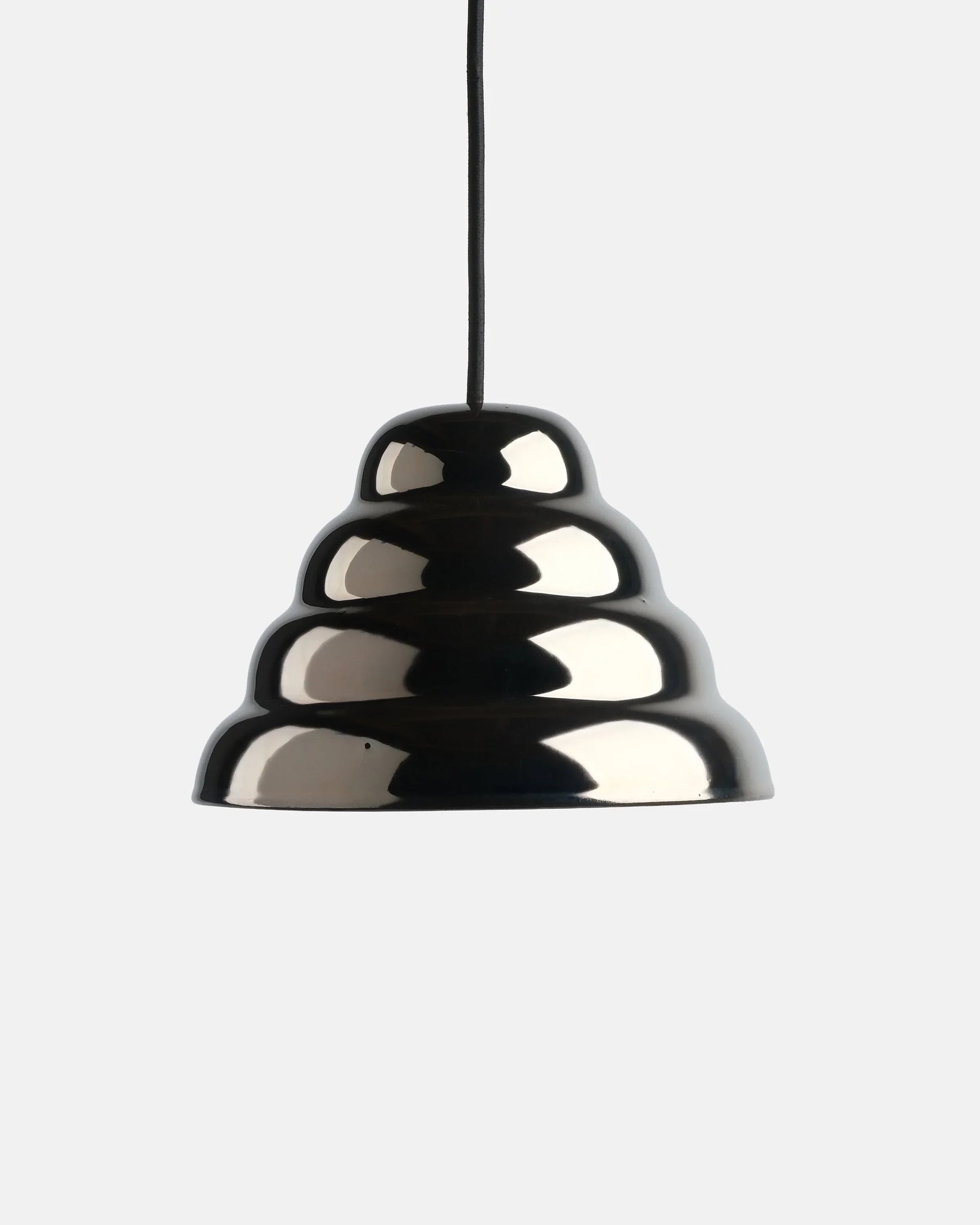 Modern ceramic pendant light showcasing a reflective metallic chrome glaze finish over a textured stepped ripple stoneware shade design against a plain studio background