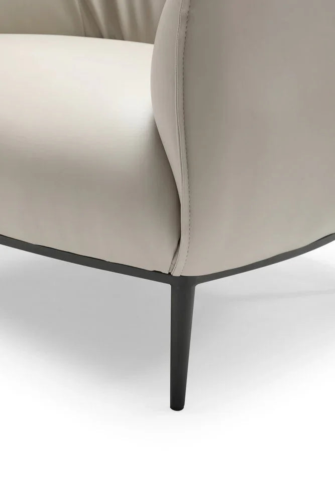 Front view of the 32 inch light gray faux leather arm chair showcasing its wide seating area and minimalist black legs.