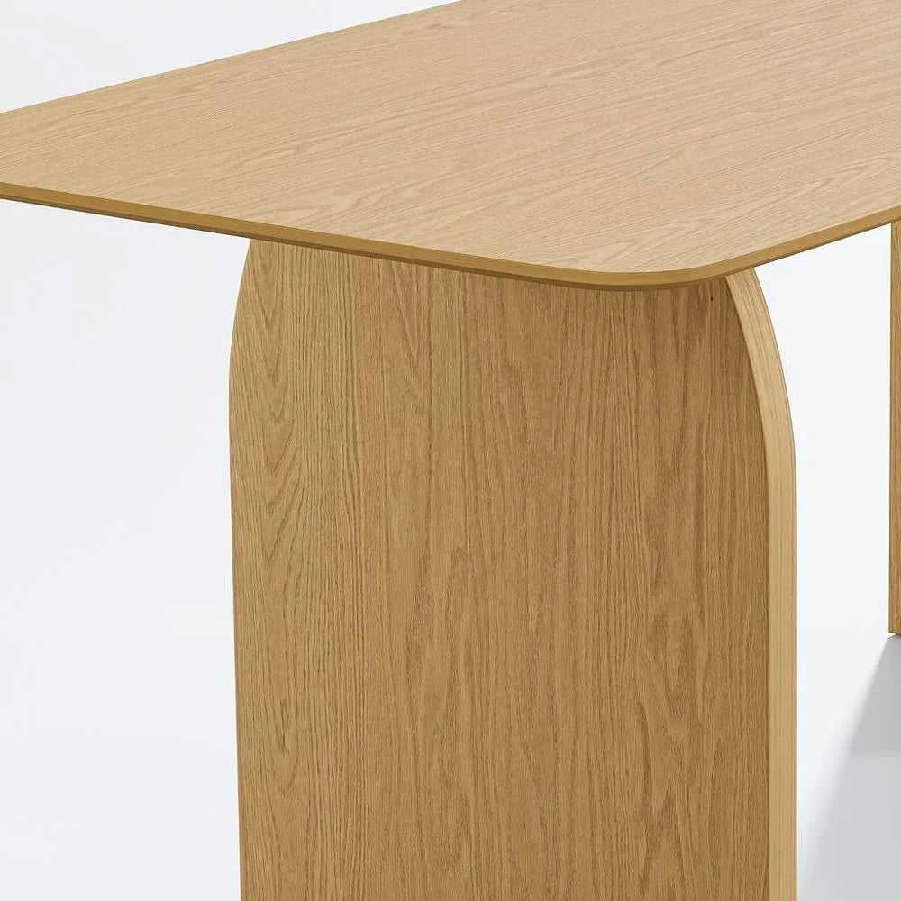 Close up detailed view highlighting the curved wooden panel design and rich grain patterns of a natural oak double pedestal dining table base
