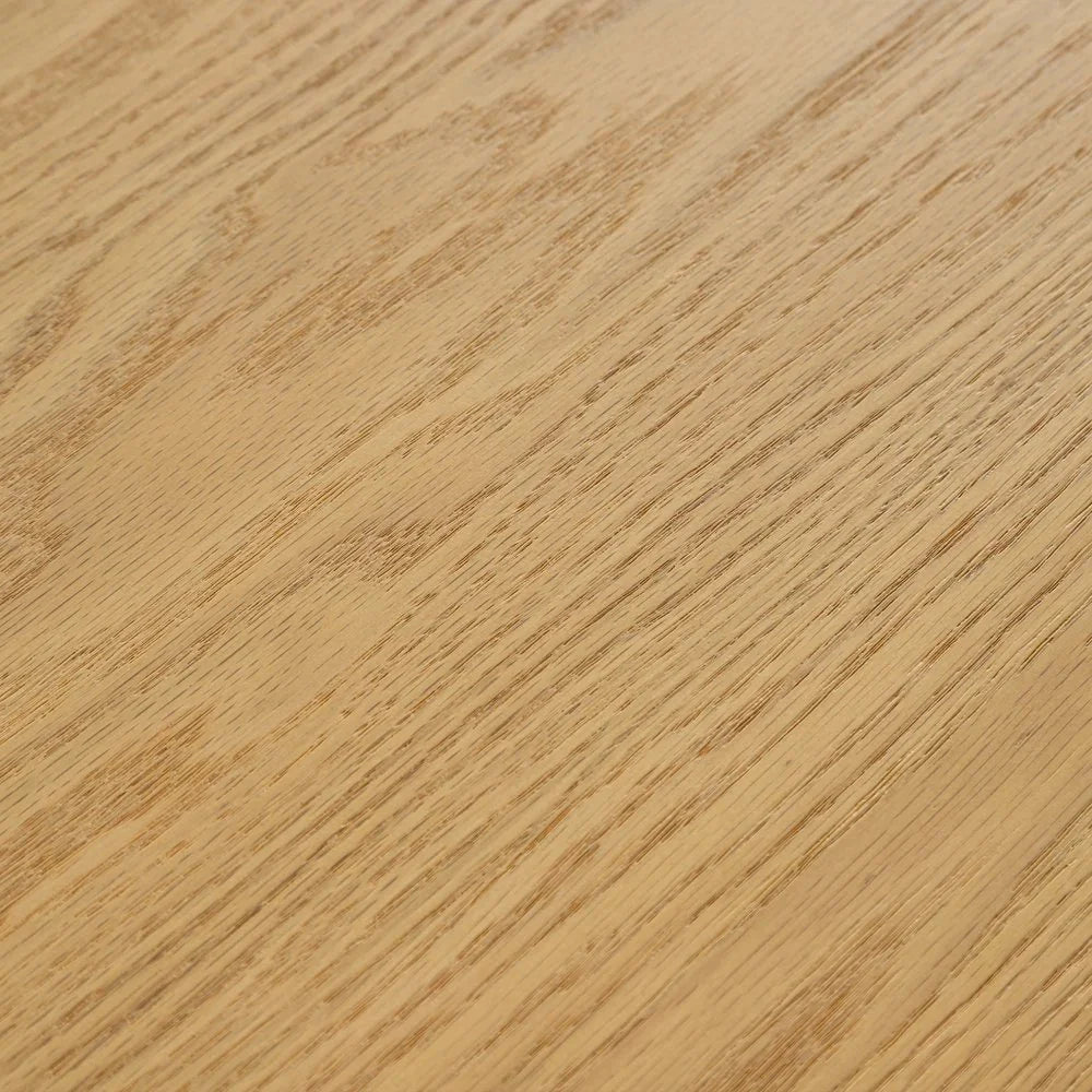 Extreme close up macro shot showing the fine natural wood grain textures and smooth light brown finish of a solid oak dining table surface