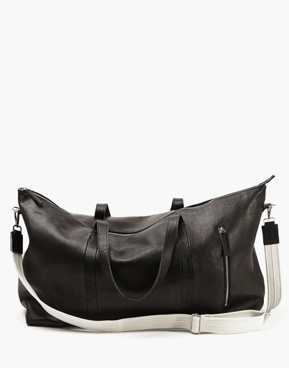 Malbec leather weekender in Black with twin handles, a cream adjustable shoulder strap, top zipper, and vertical exterior zipper.