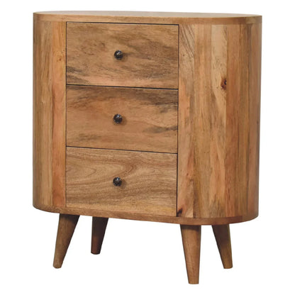 Three-quarter view of oak-ish mango wood mini cabinet showing oval body depth three drawers and four Nordic splayed legs
