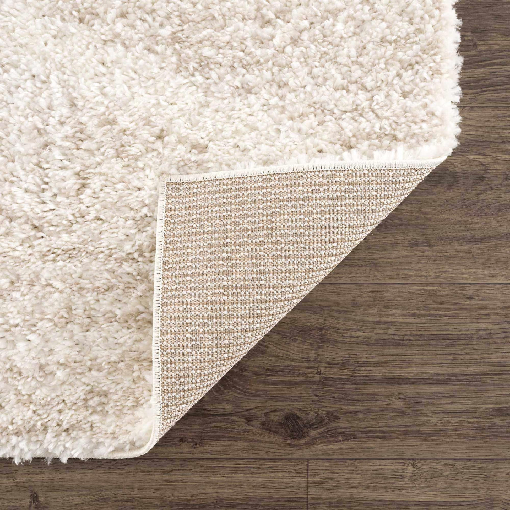 Plush Beige Shag Rug Corner Fold Showing Polyester Backing Detail | Fluent Trends