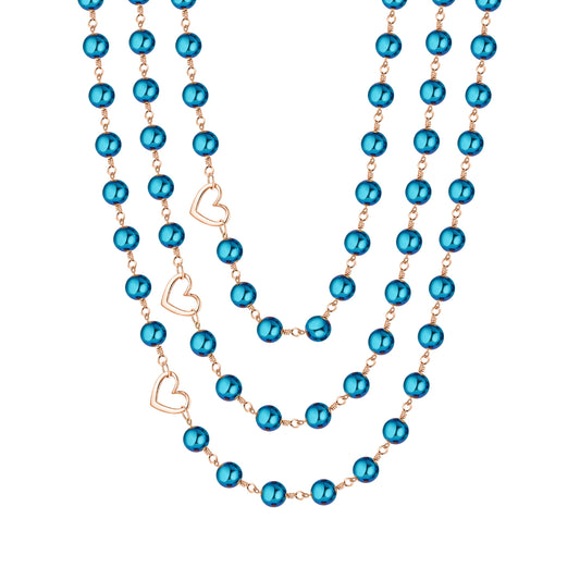 Celeste blue hematite layered necklace with three strands of reflective blue beads, copper-tone wirework, and three open heart accents on a white background.