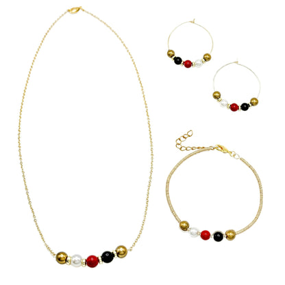 His-Story Majorca pearl bangle bracelet displayed beside a coordinating necklace and hoop earrings, featuring gold, white, red, and black beads on a white background.